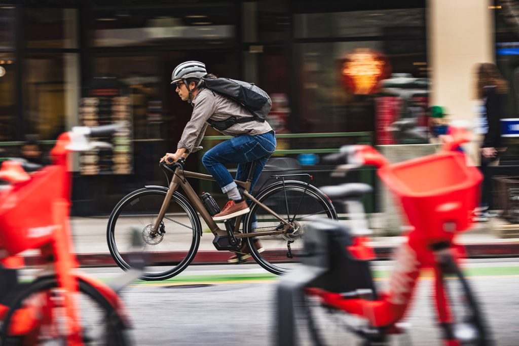 Person riding ebike in city landscape