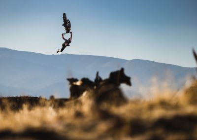 Hug backflip on motocross bike with rider's legs doing scissor kick completely away for bike.