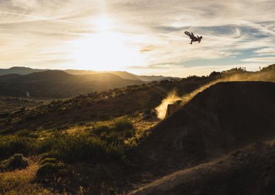 Giant motocross air with silhouette of ride in dusk.