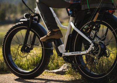 Medium close up of e-bike and mans legs on pedal ready to ride off.