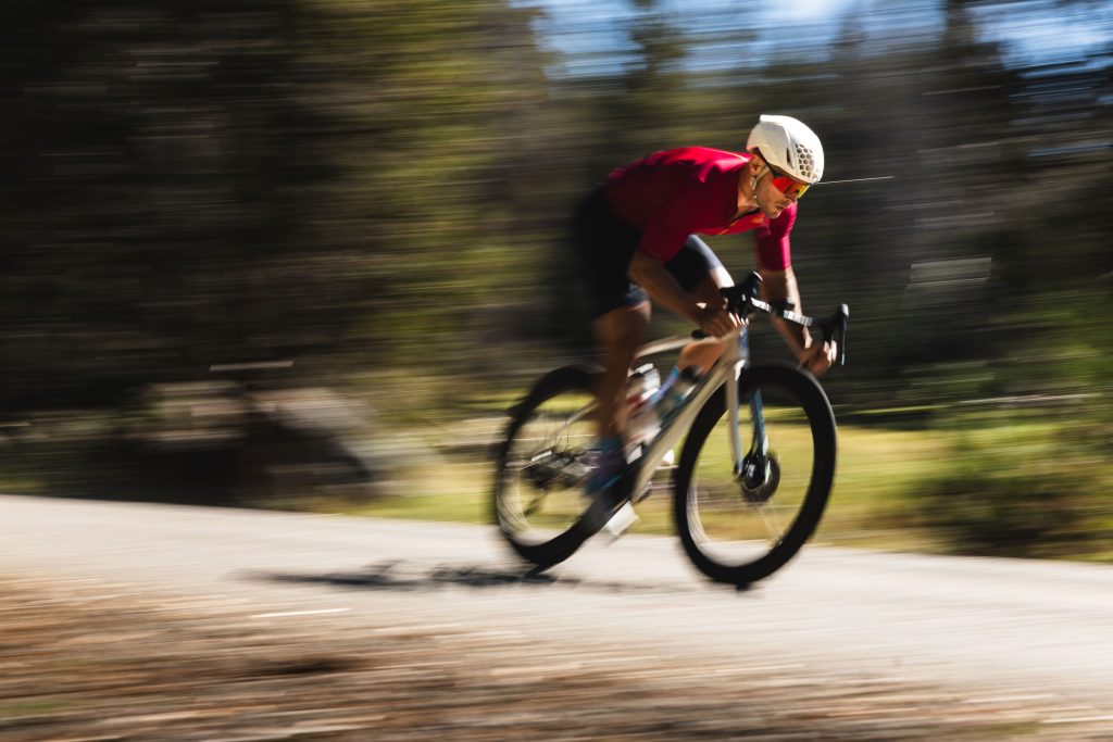 Fast road cyclist with read glasses and jersey. Cycling eyewear photo shoot by Ryan Cleek