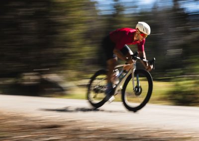 Fast road cyclist with read glasses and jersey.