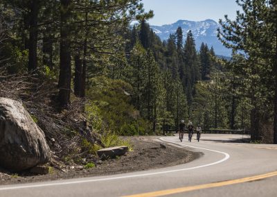 Three road cyclist on mountain trial climbing.