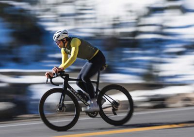 Photograph of road cyclists descending fast in winter conditions.