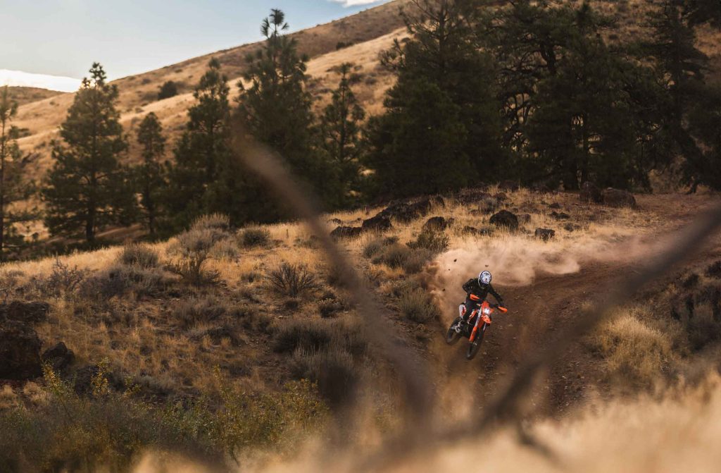 Dirt bike rider ripping through a berm in Peavine outside of Reno, NV.