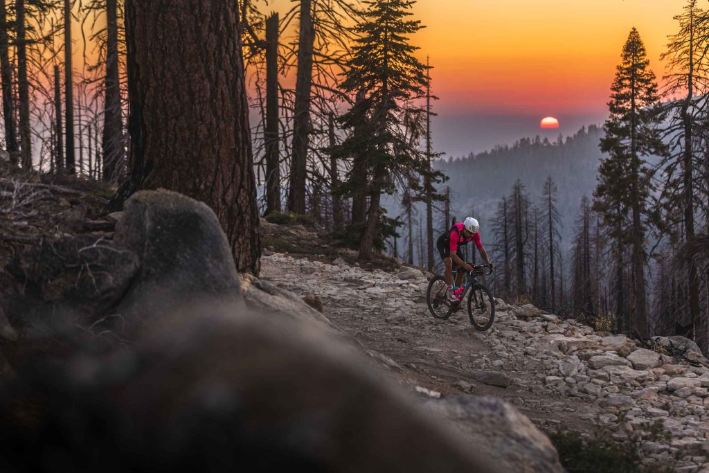 Pro endurance cyclist, Tyler Pearce, on his Canyon gravel bike in the Yosemite area as a wildfire burns in the distance. Photo by Ryan Cleek